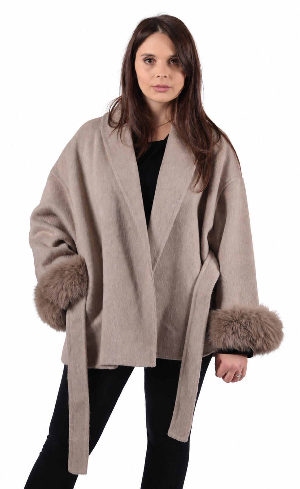 A woman wearing a taupe cashmere and wool coat with detachable real fox fur cuffs.
