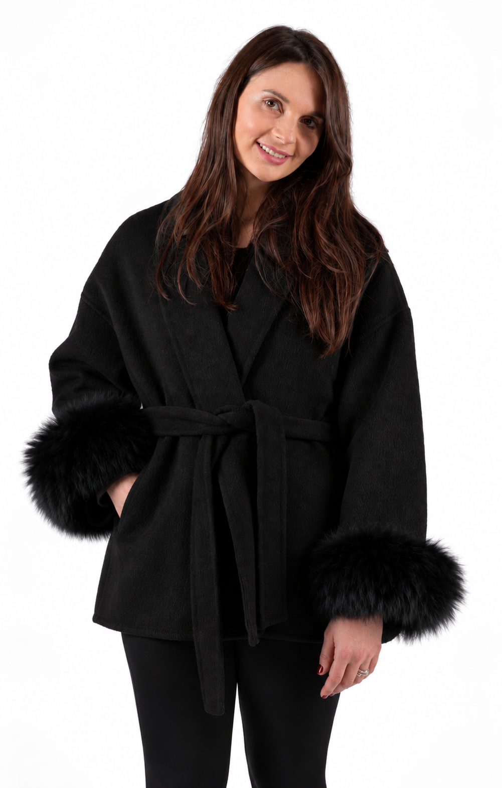 Woman wearing a black cashmere and wool coat with detachable real fox fur cuffs by Neige Paris.