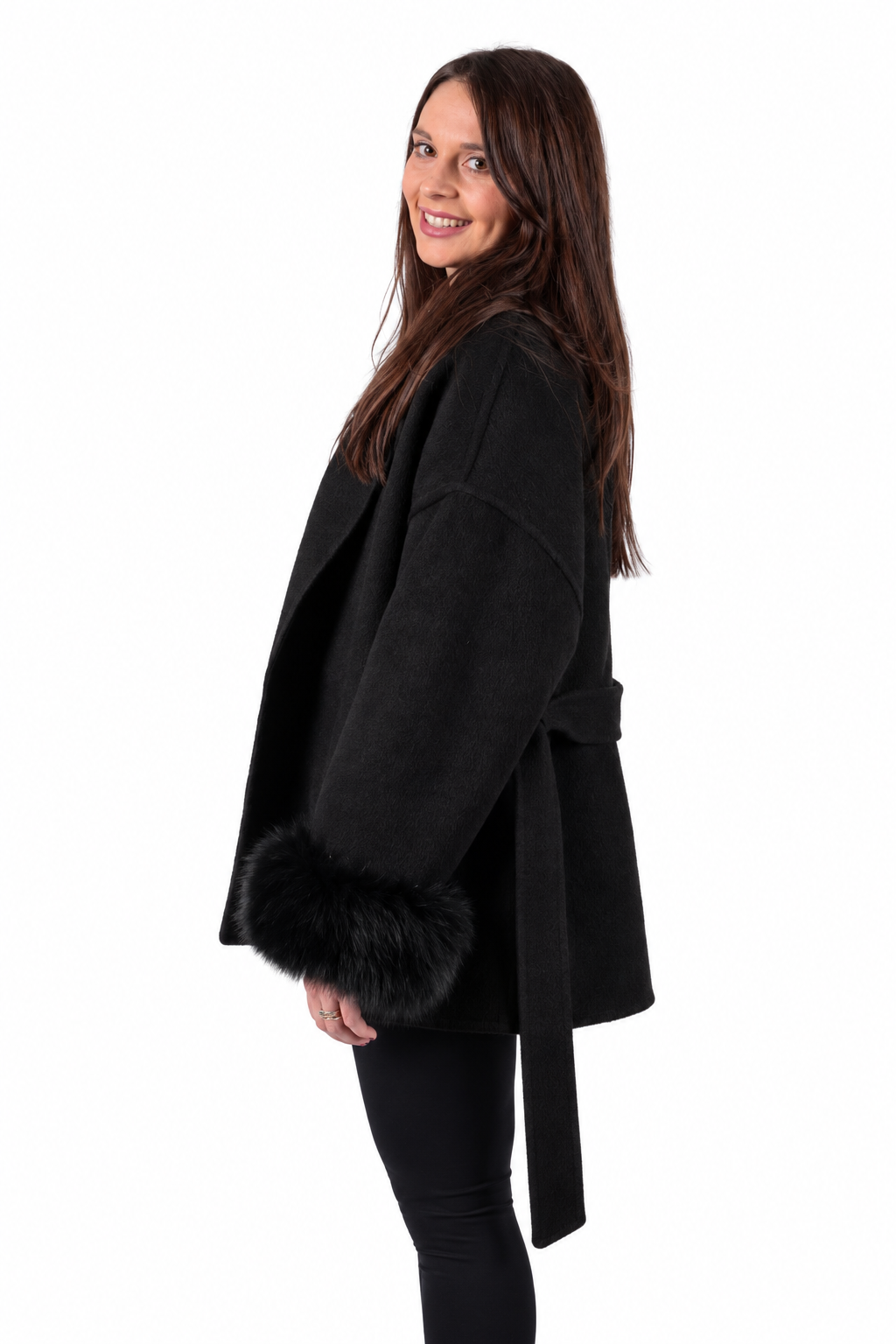 A woman wearing total black with a coat made of cashmere and wool and detachable real fox fur cuffs